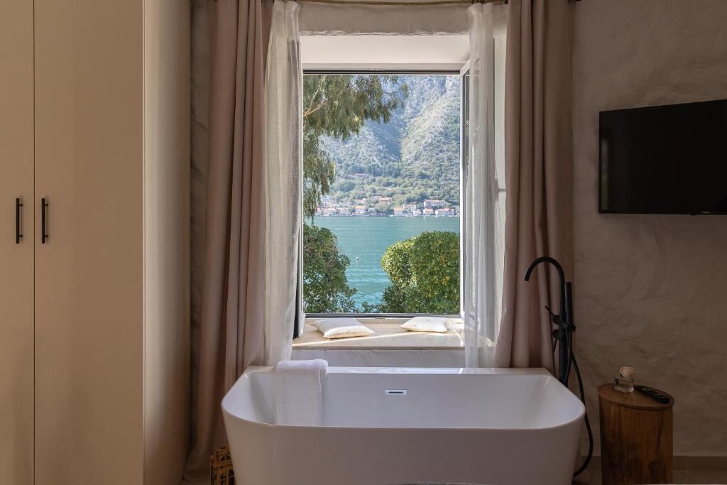 Bath by the window with a view over the Bay of Kotor at VerDi in Dobrota