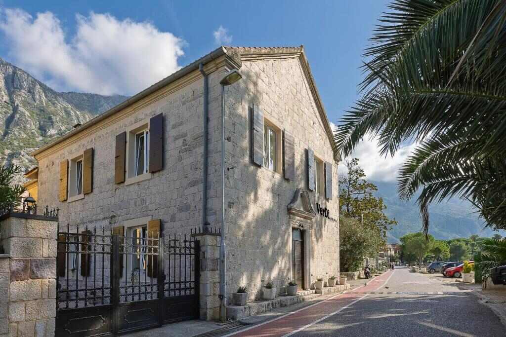 The stone house of VerDi apartments on the waterfront road in Dobrota, Kotor