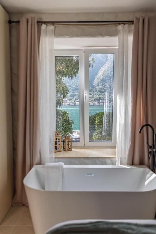 Bathtub facing a window with a view of the Bay of Kotor at VerDi