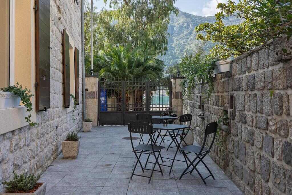 Stone courtyard with outdoor seating at VerDi in Dobrota